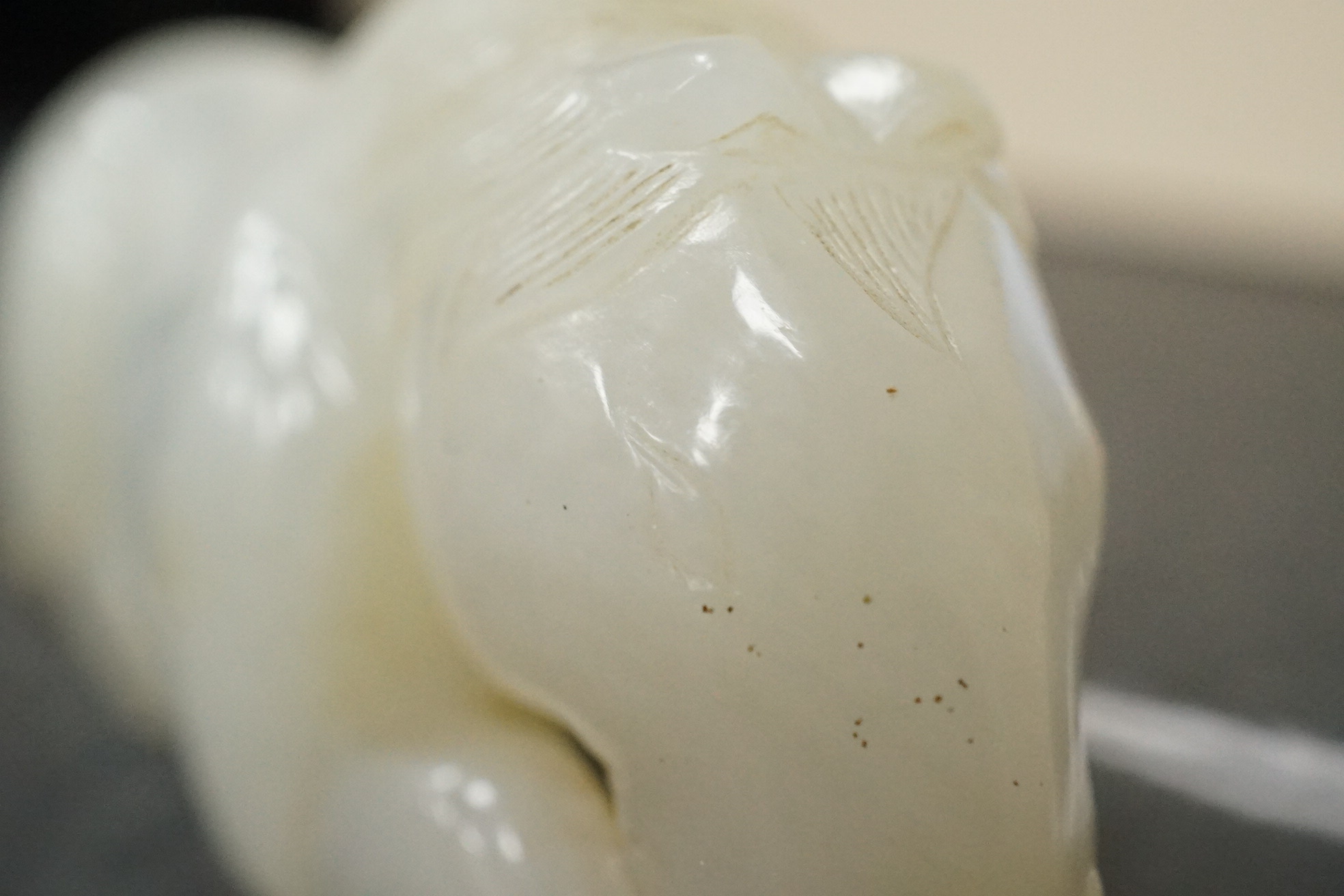 A Chinese white jade figure of a recumbent horse